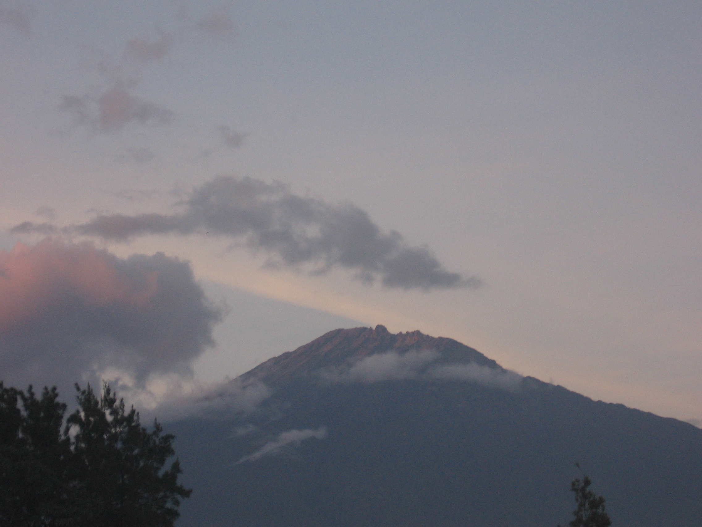 Mount Meru rising beyond the green landscape near Arusha, Tanzania