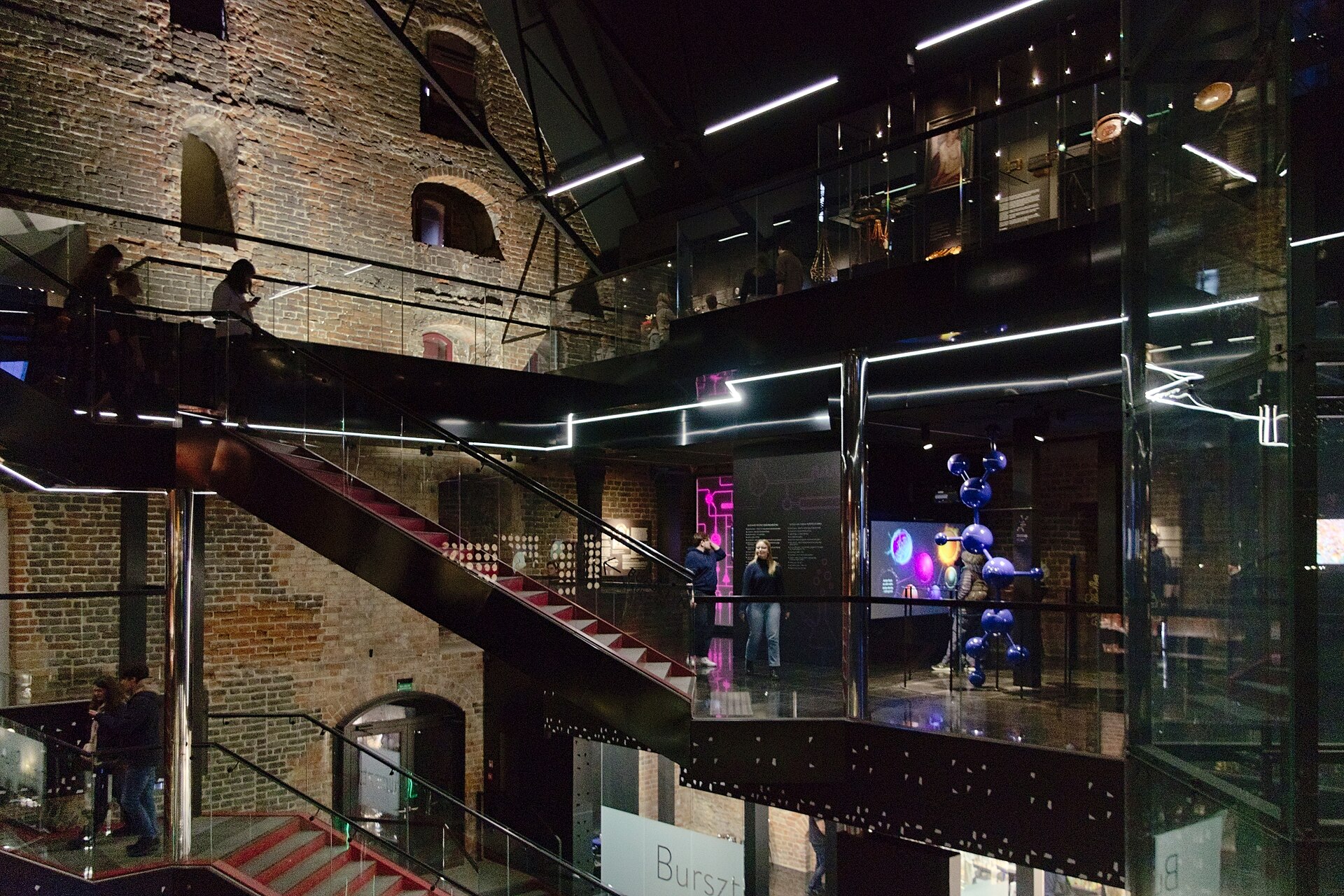 Brick walls, stairs and illuminated displays inside Gdańsk’s Amber Museum in the Great Mill