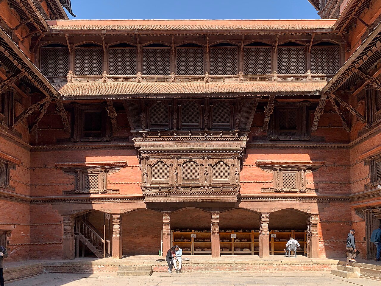 Carved wooden windows and brick façades around Lohan Chowk at Hanuman Dhoka in Kathmandu