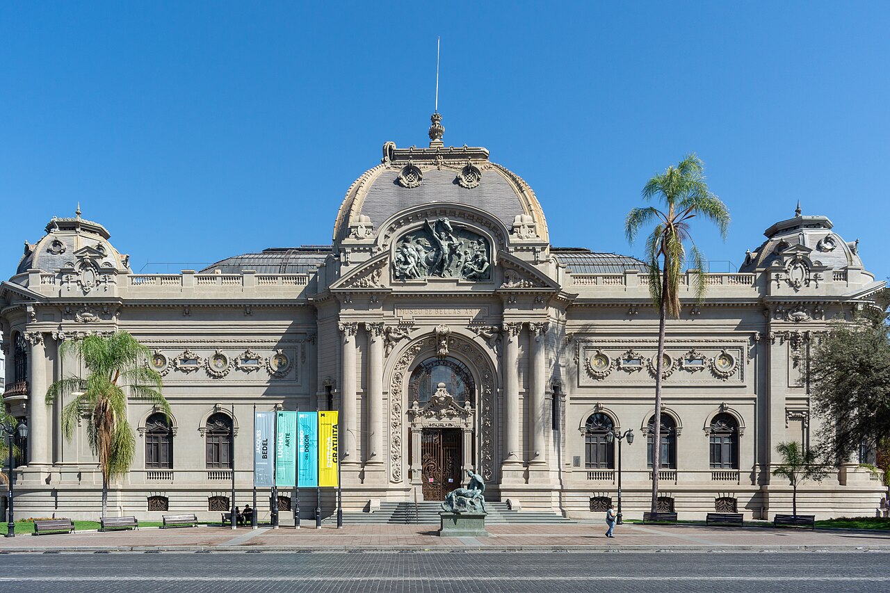 Ornate stone façade and central dome of Santiago’s Museo Nacional de Bellas Artes, with palm trees beside the entrance.