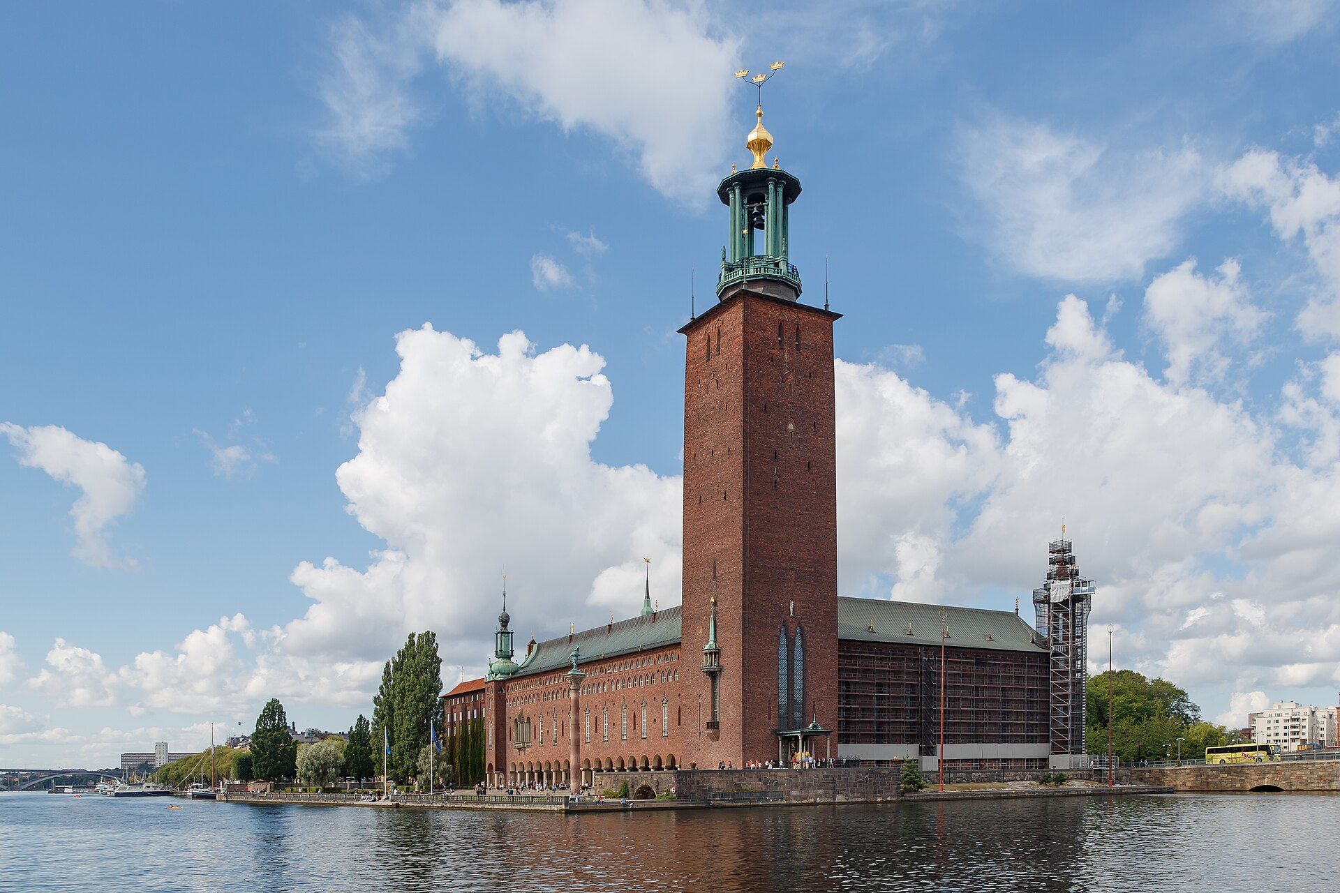 Stockholm City Hall and its brick tower beside Riddarfjärden, with scaffolding visible in this 2016 view.