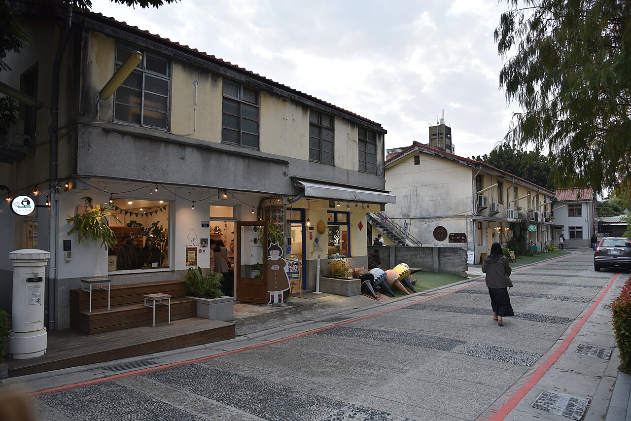 Small shopfronts in former residential buildings along a lane at Shenji New Village in Taichung.